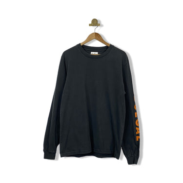 A long sleeve black t-shirt with orange text on the sleeves, displayed on a hanger against a white background.